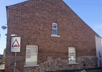 Brick repointing work on the side of the house completed